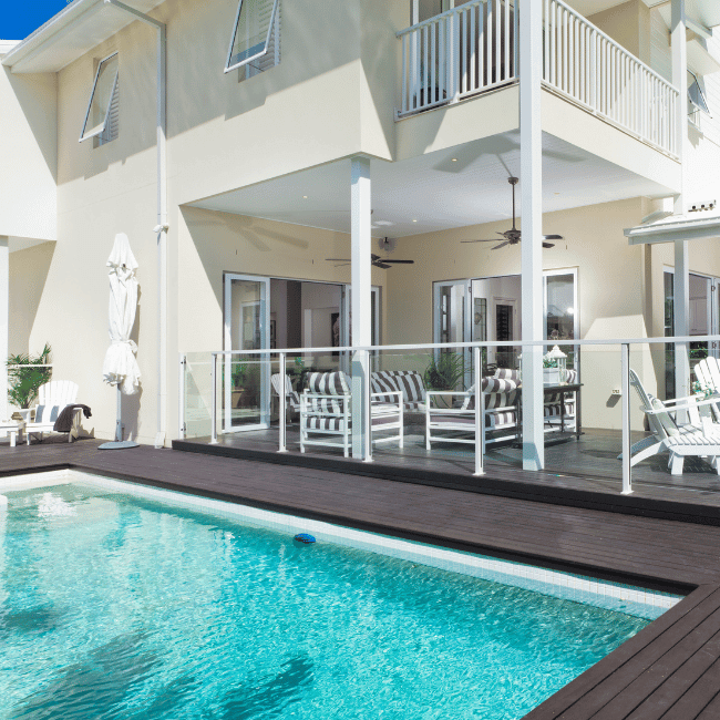 A Large House With A Swimming Pool In Front Of It — Howells & Co Legal & Conveyancing In Cessnock, NSW