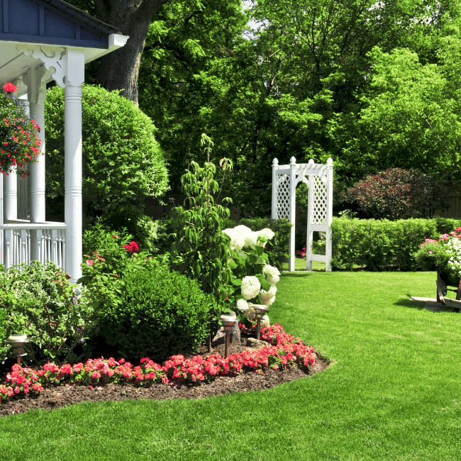 A House With A Large Lawn And Flowers In Front Of It — Howells & Co Legal & Conveyancing In Cessnock, NSW