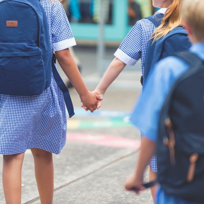 A Girl In A Blue Dress Is Holding A Boy's Hand — Howells & Co Legal & Conveyancing In Cessnock, NSW