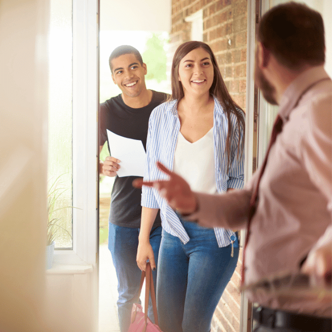 A Man And A Woman Are Standing In A Doorway Talking To Each Other — Howells & Co Legal & Conveyancing In Cessnock, NSW