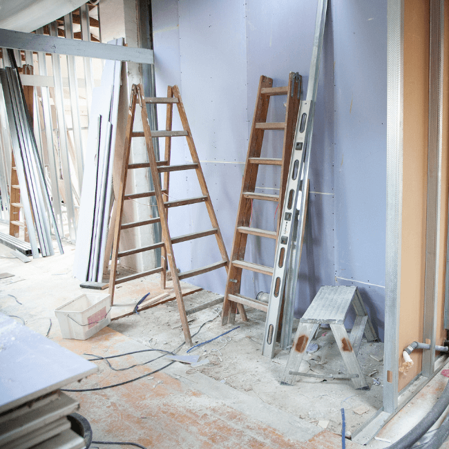 A Room Under Construction With Ladders And A Stool — Howells & Co Legal & Conveyancing In Cessnock, NSW