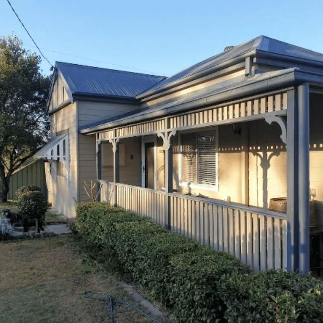 A House With A Porch And A Blue Roof — Howells & Co Legal & Conveyancing In Cessnock, NSW