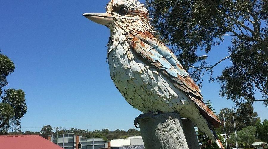 A Statue Of A Bird Is Sitting On Top Of A Pole — Howells & Co Legal & Conveyancing In Cessnock, NSW