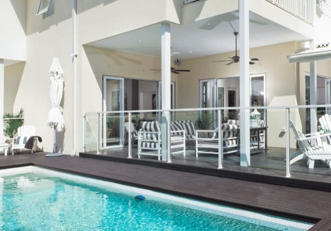 A Large House With A Swimming Pool In Front Of It — Howells & Co Legal & Conveyancing In Cessnock, NSW