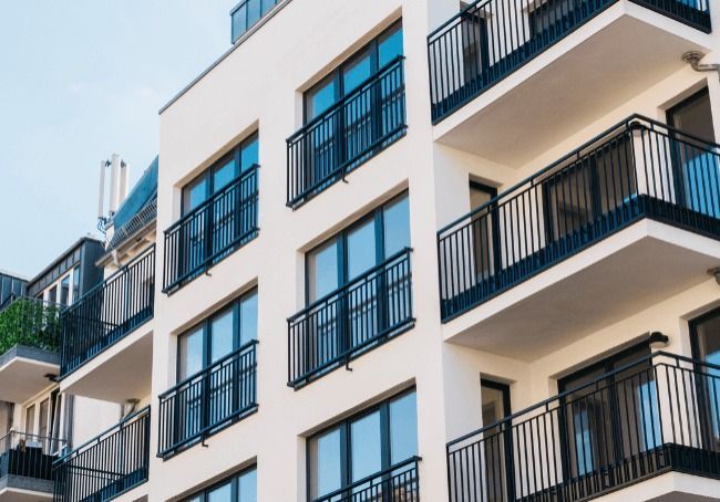 A Large Apartment Building With Lots Of Windows And Balconies — Howells & Co Legal & Conveyancing In Cessnock, NSW