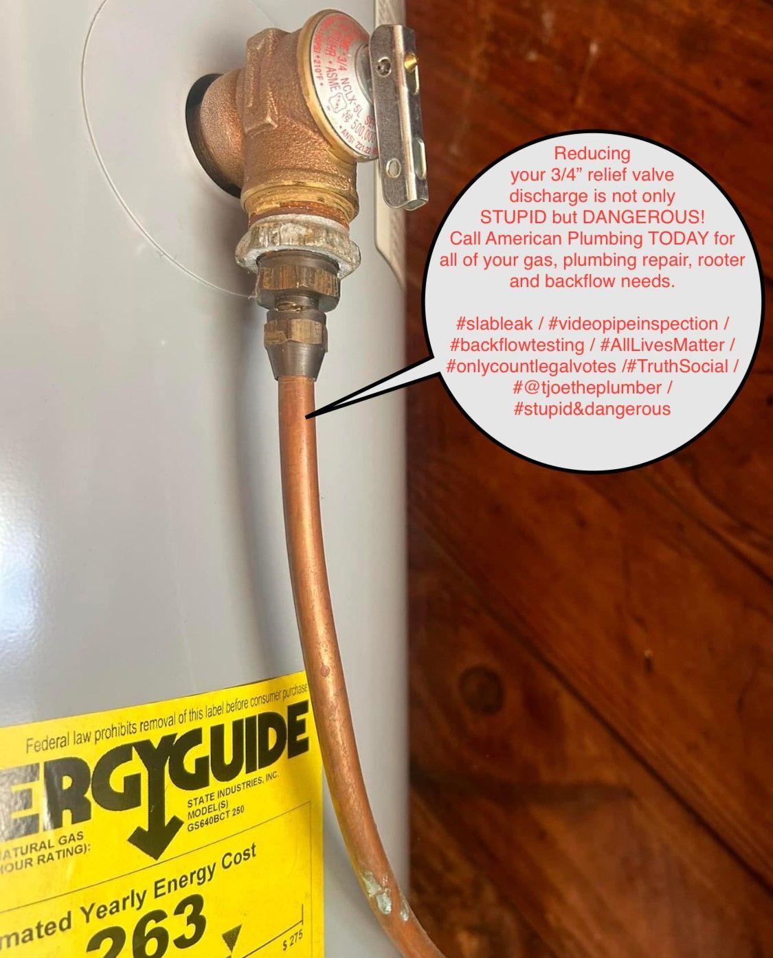 A copper pipe connected to a water heater, with a warning about discharge.