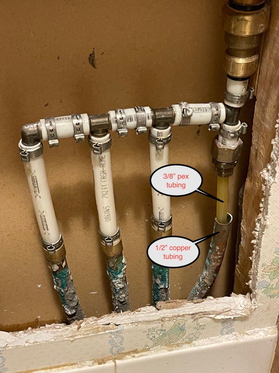 Plumbing pipes in a wall cavity with callouts marking 1/2