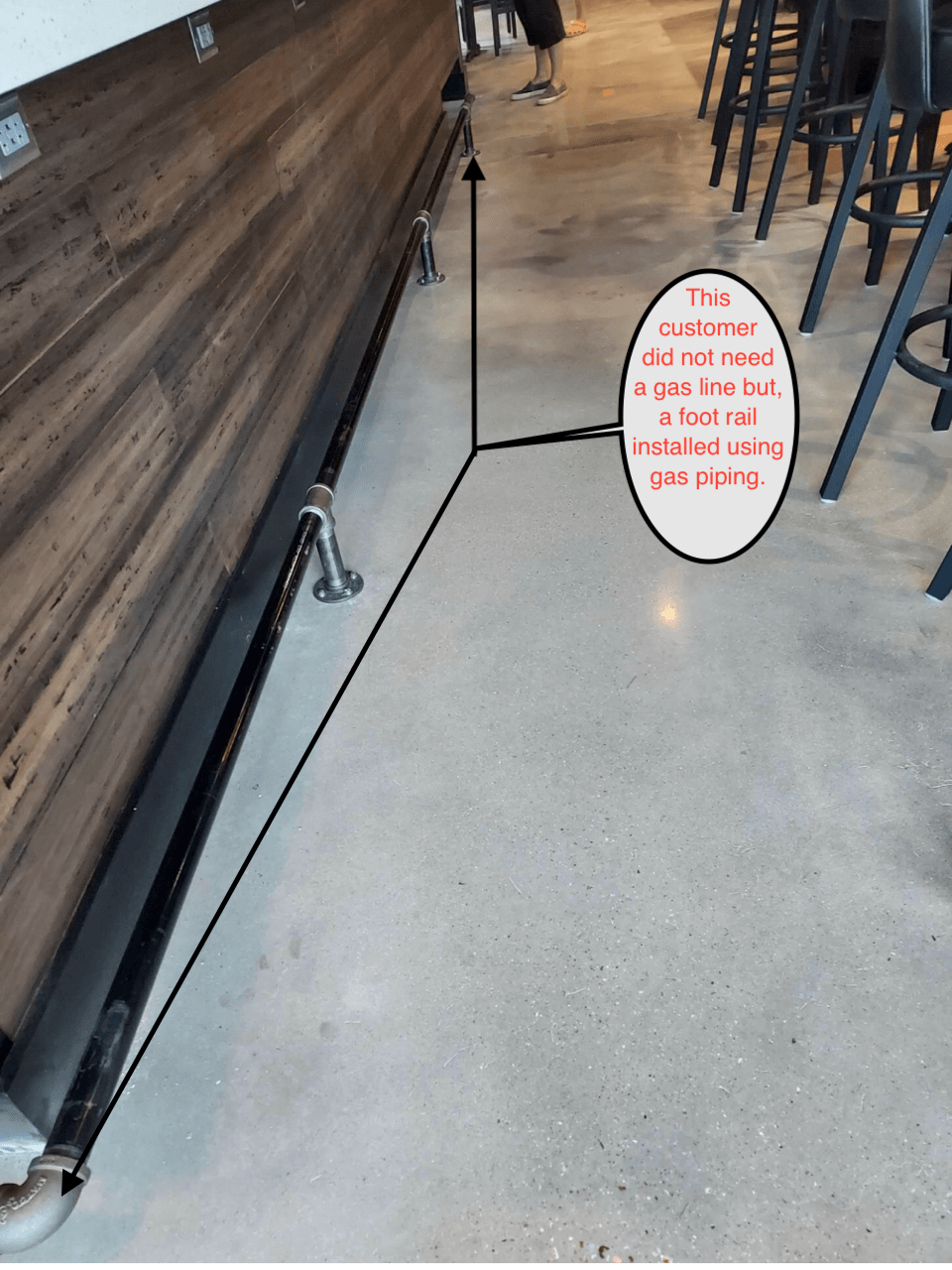 Restaurant floor with an oval sign reading “I AM OUT OF ORDER…” beside the bar area