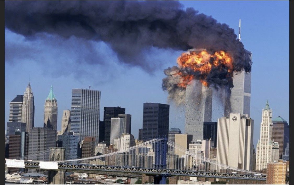 New York City skyline with the Twin Towers engulfed in flames and smoke during an attack