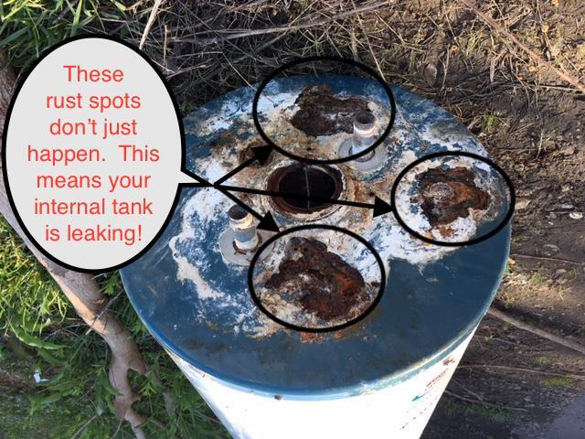 Blue metal tank with rust spots circled and warning text about an internal tank leak