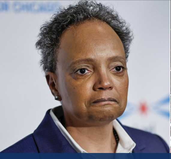 Lori Lightfoot, former Chicago mayor, in a navy blazer. She has gray curly hair and a neutral expression.