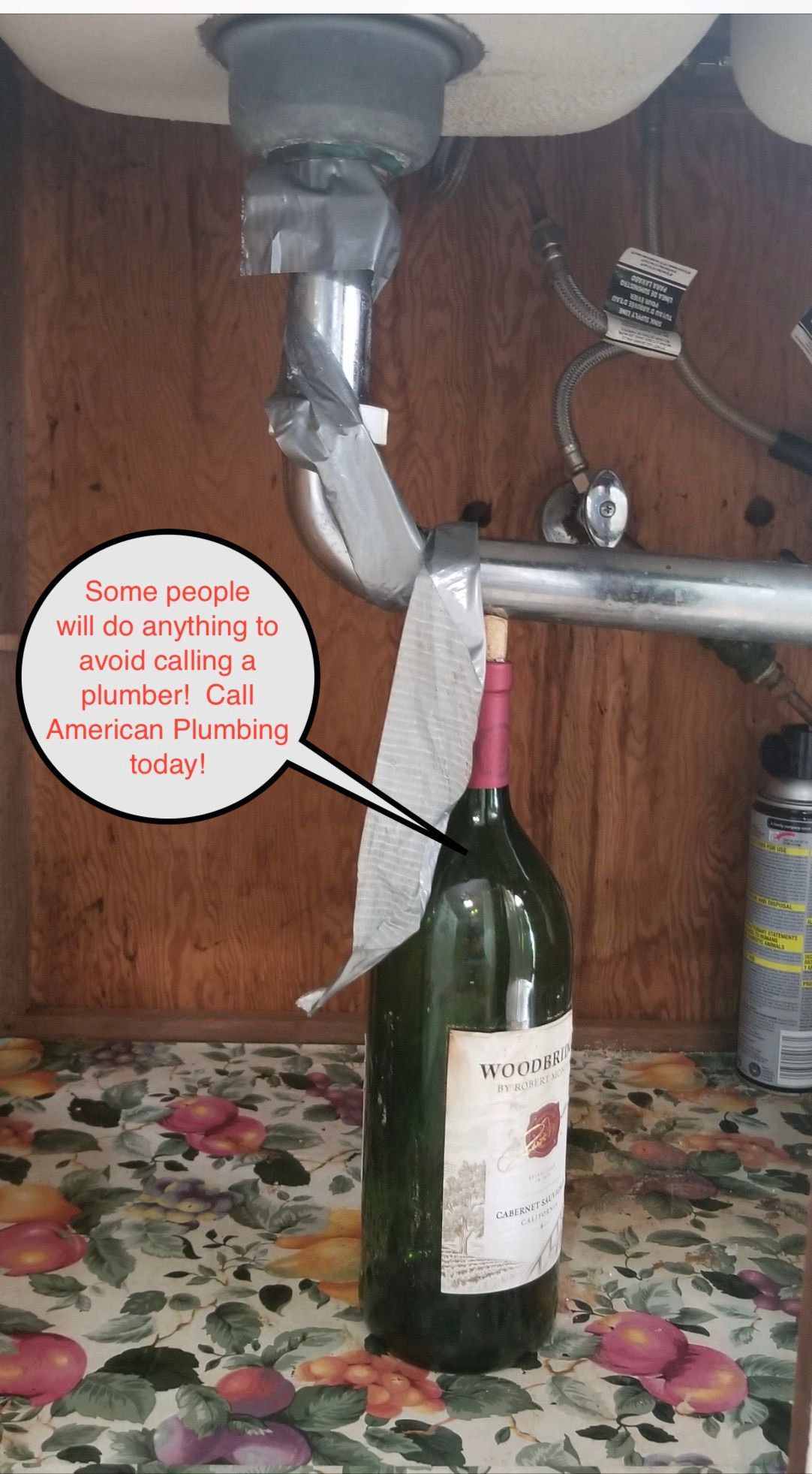 Wine bottle under a kitchen sink with a faucet and hose filling it with liquid