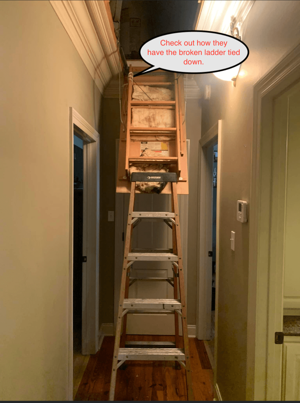 Stacked step ladders in a narrow hallway reaching up to a cabinet near the ceiling.