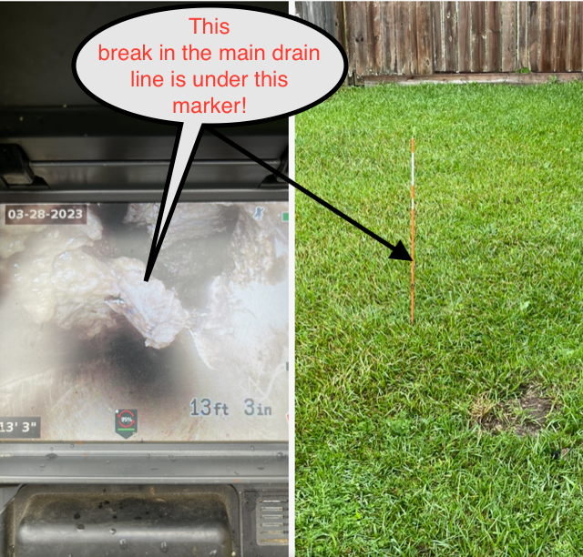 A camera view of a broken drain line and a marker in a grassy yard, indicating the break location.