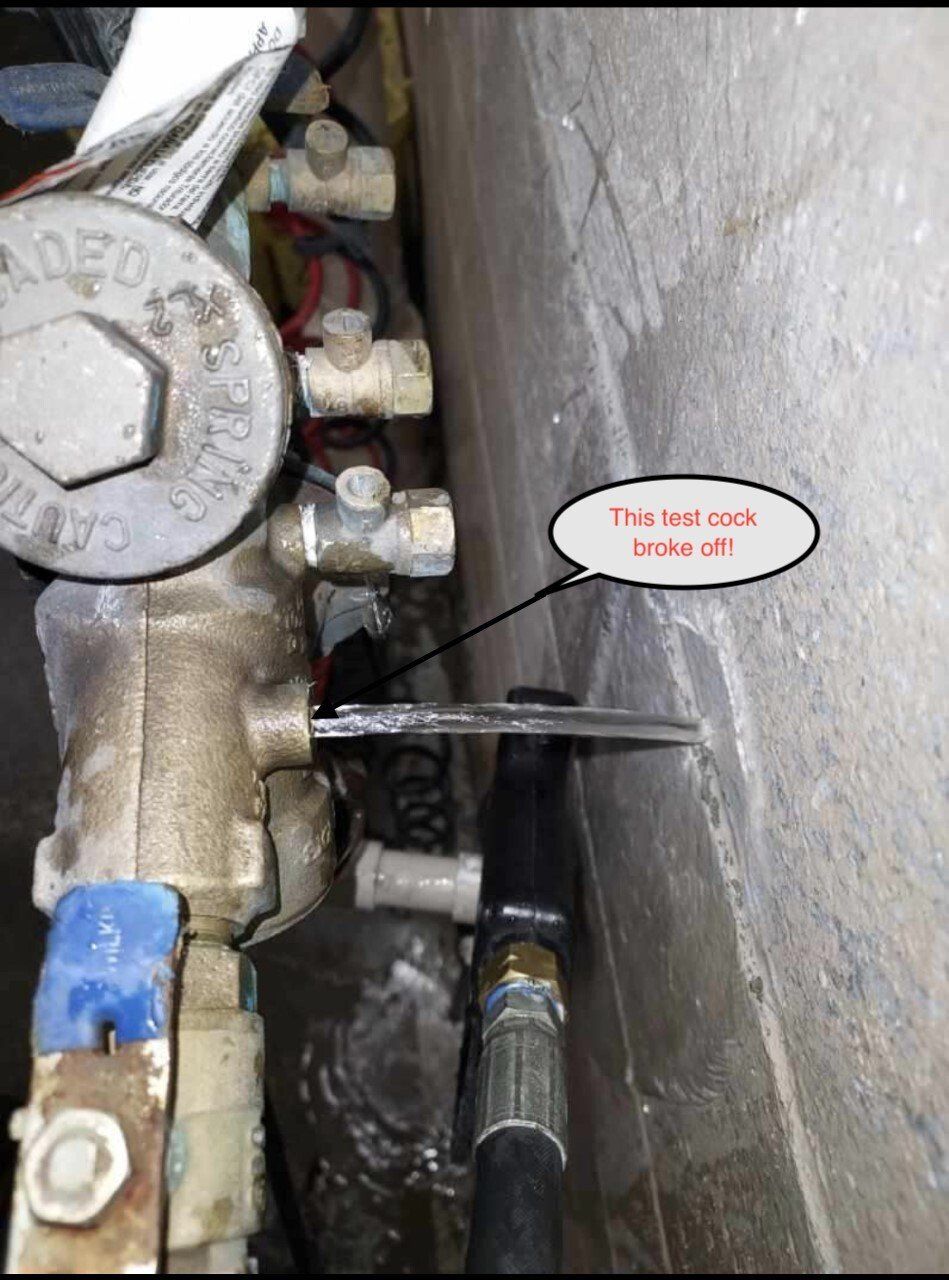 Close-up of a pipe valve with a label reading “The nut broke loose off” pointing to a broken rod.