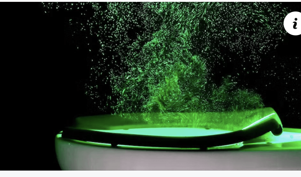 Green glowing liquid bubbling in a white bowl with a spoon on a black background