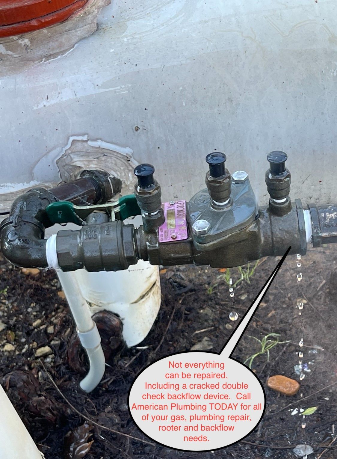 Water meter with black pipes and valves on a concrete surface outdoors