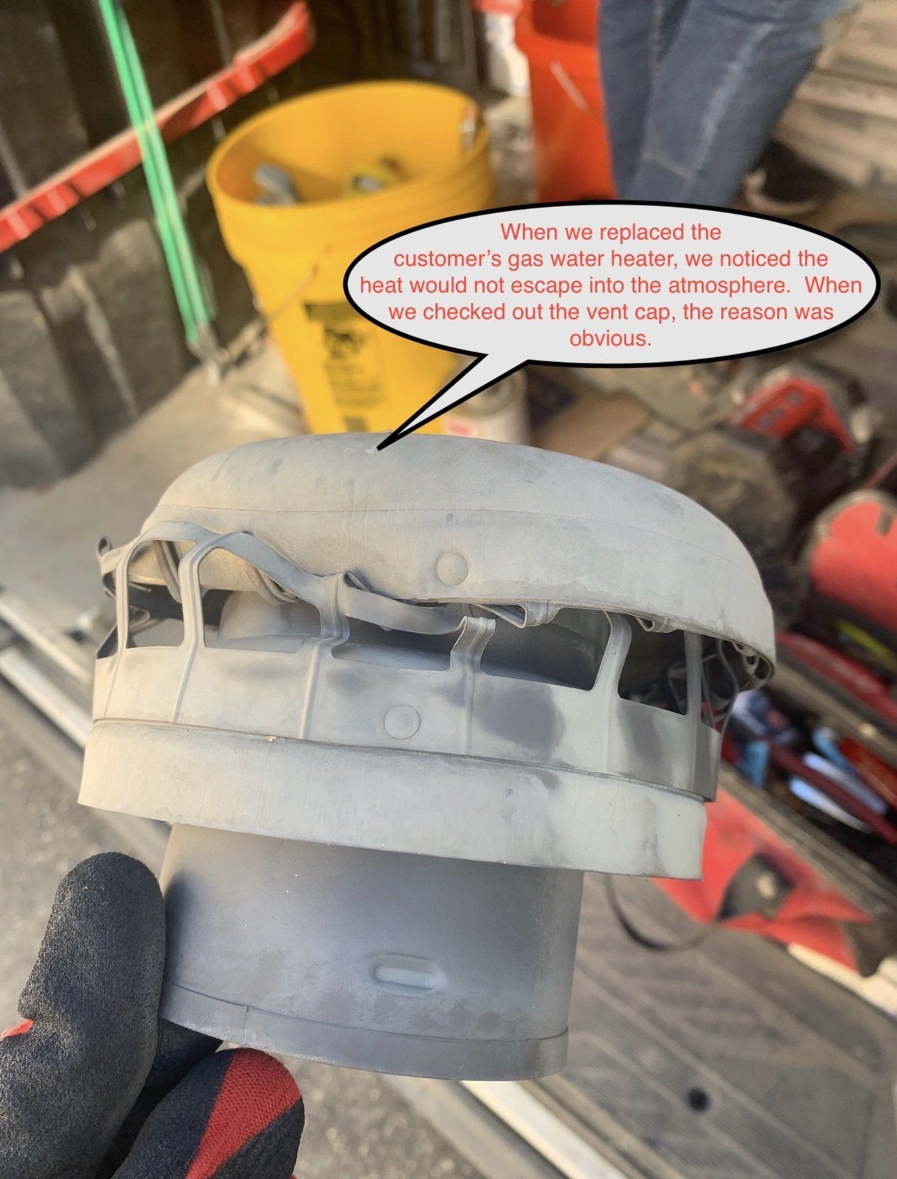 Dusty gray plastic HVAC motor housing with a speech bubble in a cluttered workshop.