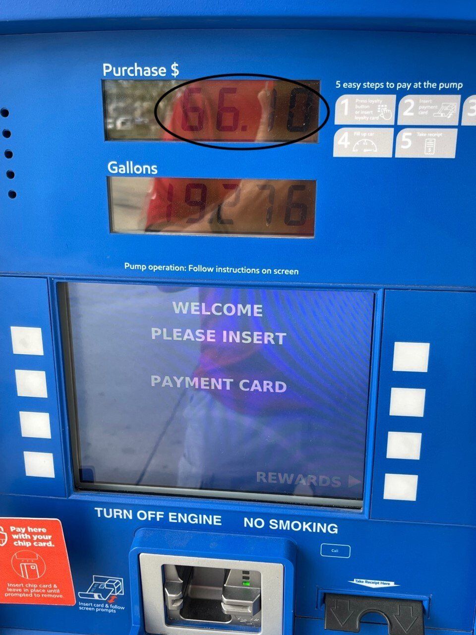 Gas pump screen displaying purchase amount and “please insert payment card” message