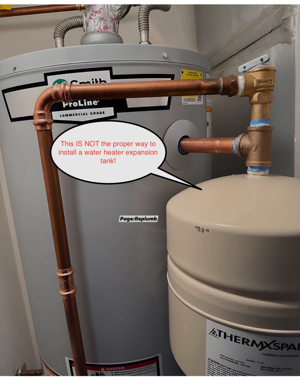 Water heater and expansion tank connected by copper pipes in a utility closet.