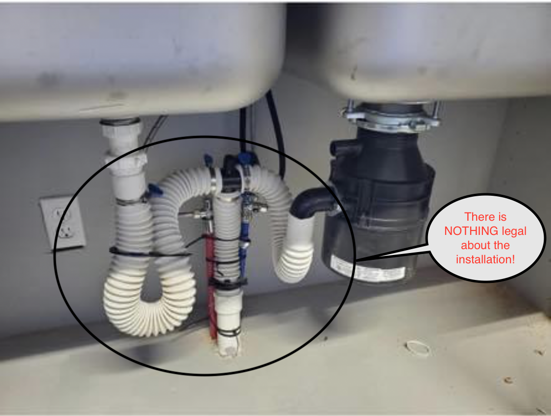 Undersink plumbing with a garbage disposal and a flexible, improperly installed trap.