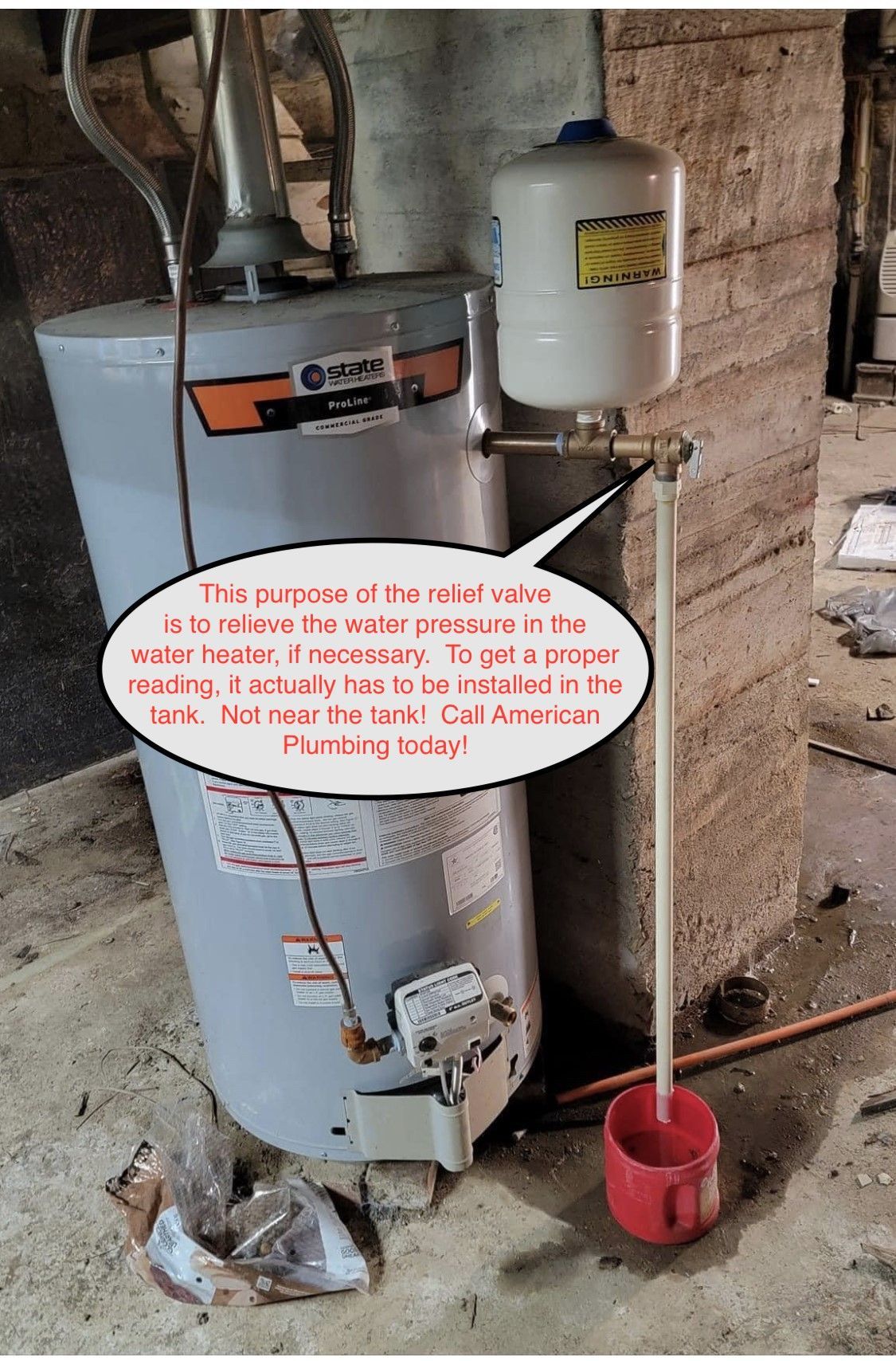 Old water heater with a red warning sign and a red bucket in a basement utility area