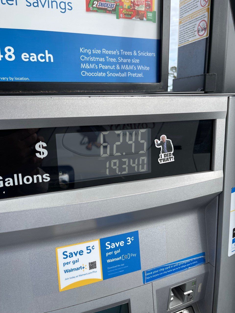 Gas pump display showing 62.45 gallons and $193.40 with fuel price signs above
