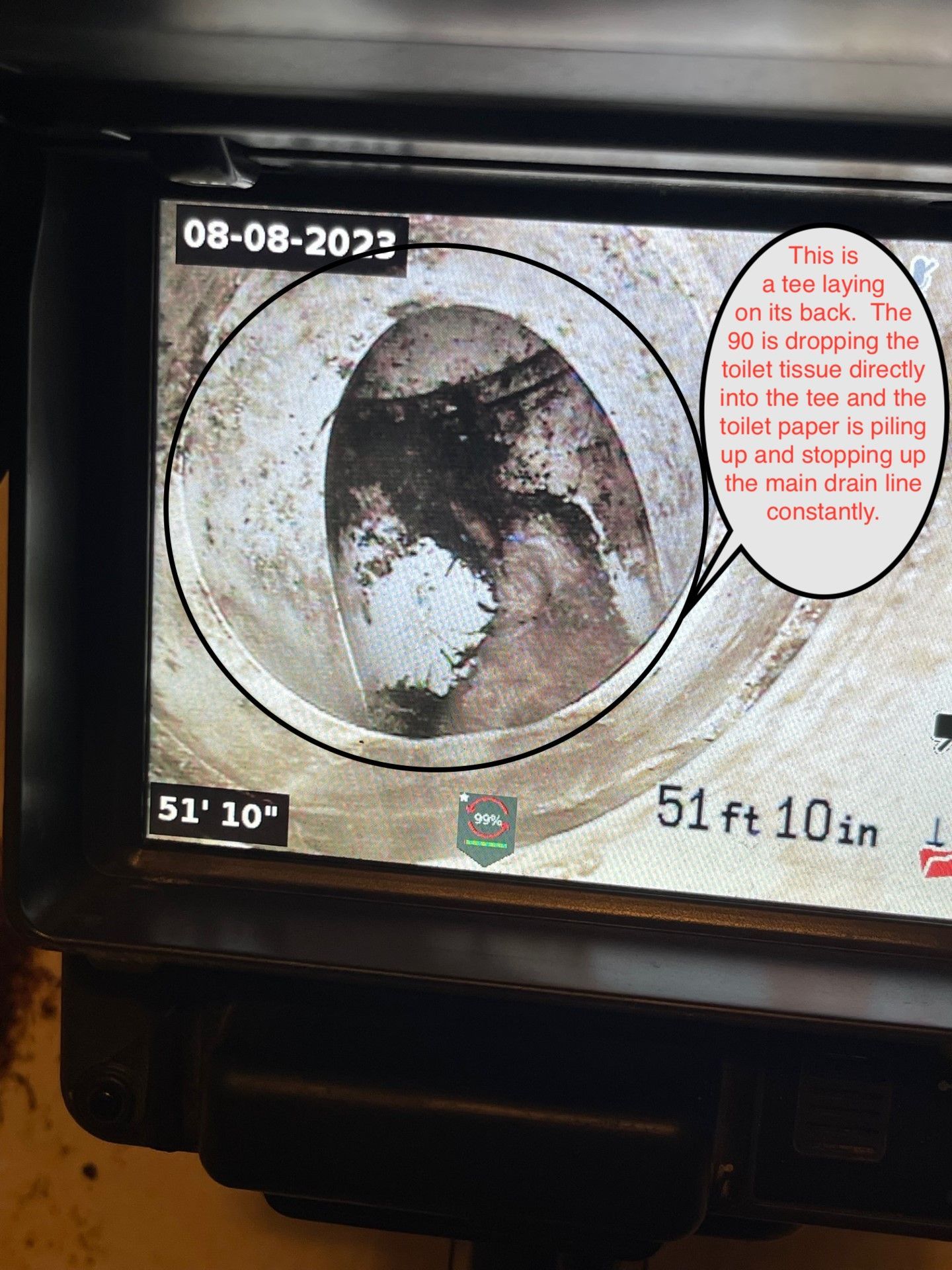 Sewer pipe camera view showing debris buildup at 51' 10