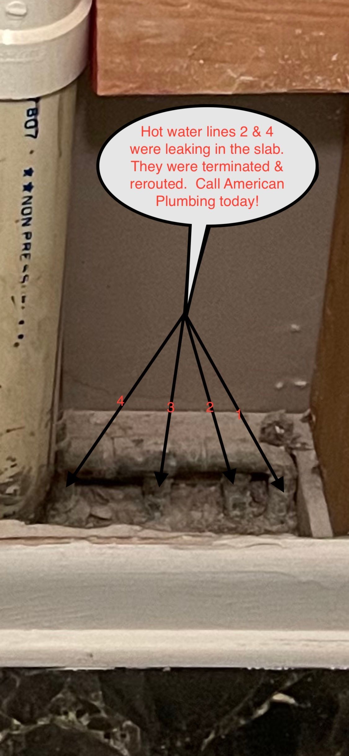 Handwritten sign taped to a brown wall above a small tripod-like metal stand in a corner.