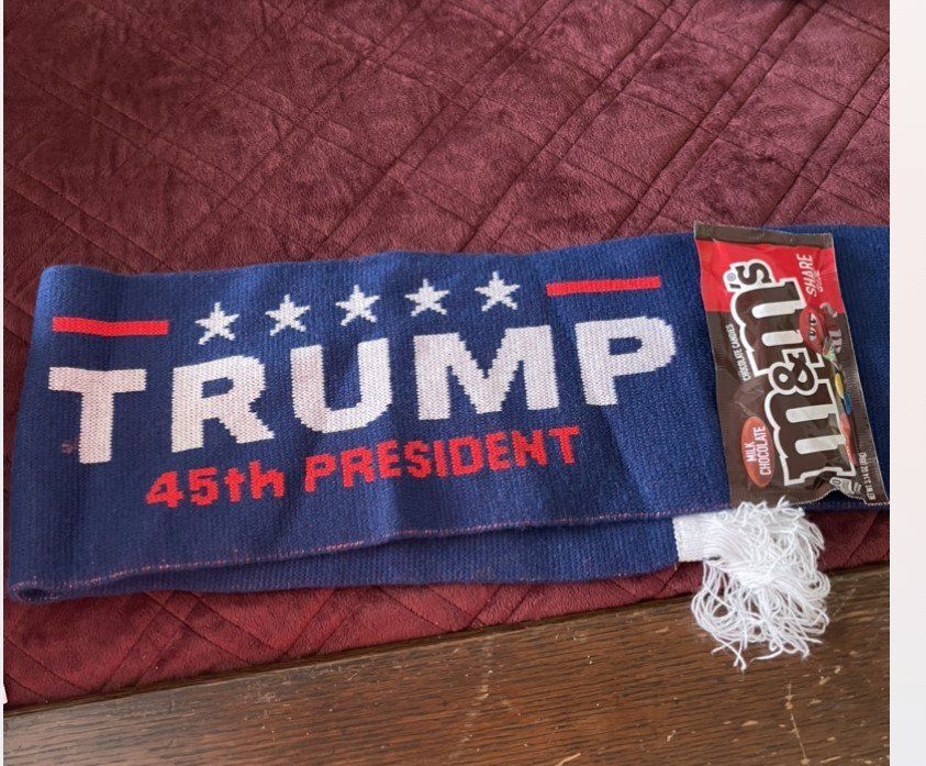 Blue Trump 45th President towel with stars and red accents on a wooden floor