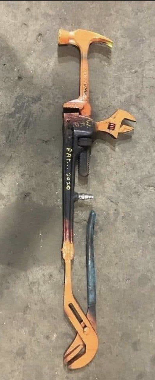 An unusual multi-tool with a hammer, wrench, and pliers attached to a long handle.