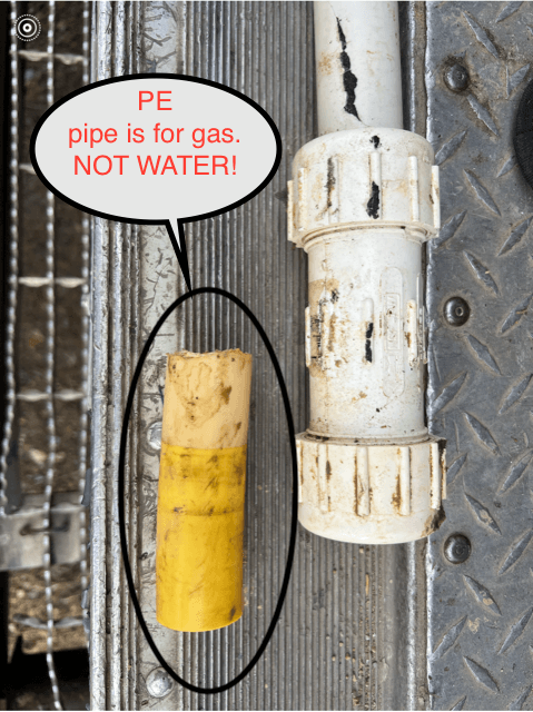 Yellow and white pipes on a metal surface, with text warning the yellow pipe is for gas, not water.