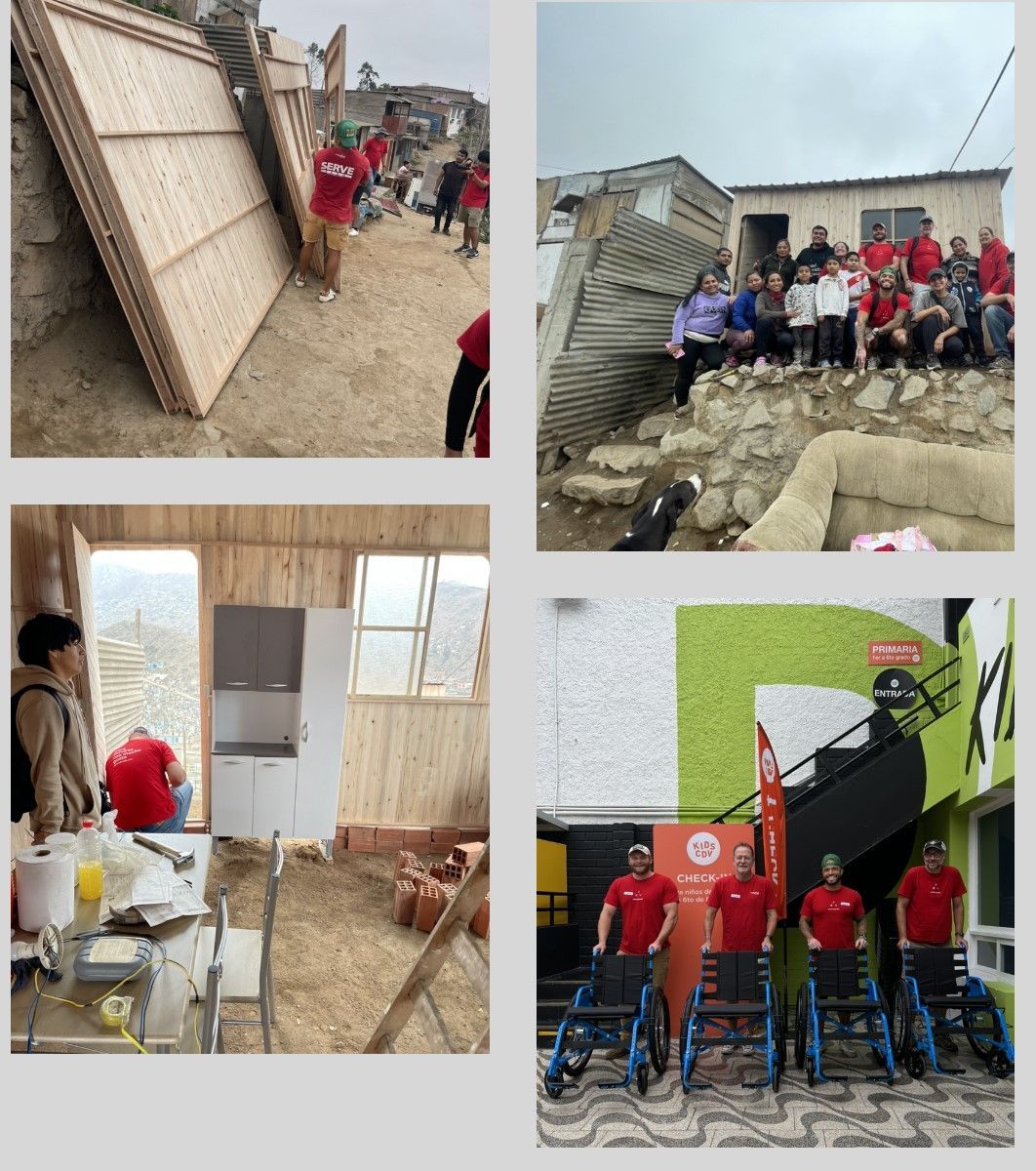 Volunteers in red shirts clean up storm damage around damaged buildings and debris.