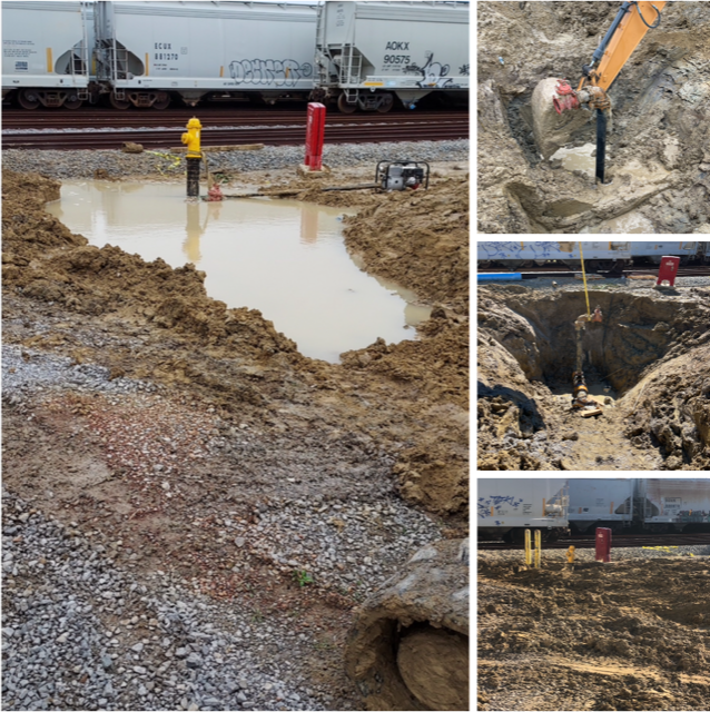 Flooded construction trench beside railcars, with workers and yellow pipe around muddy excavation.