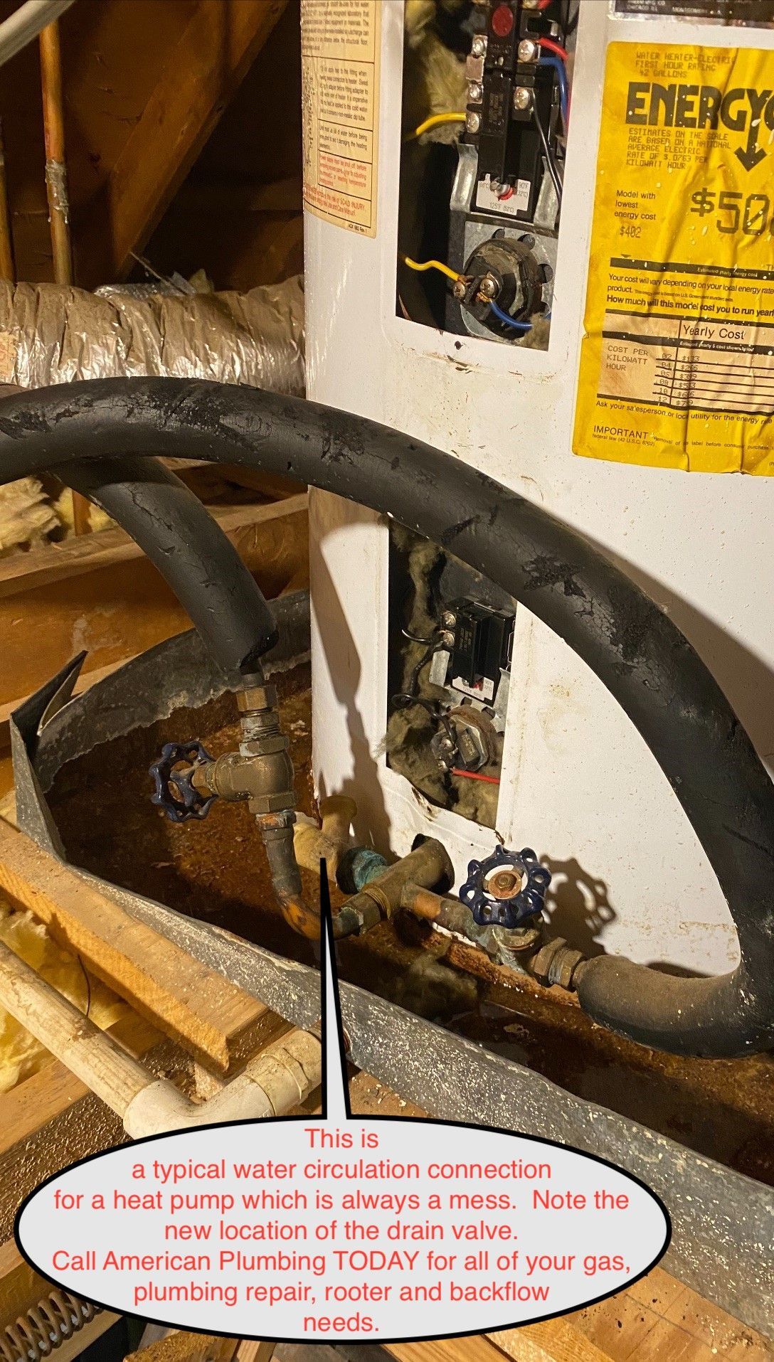 Black hose and rusty tank in a cramped mechanical area with yellow warning label and debris below