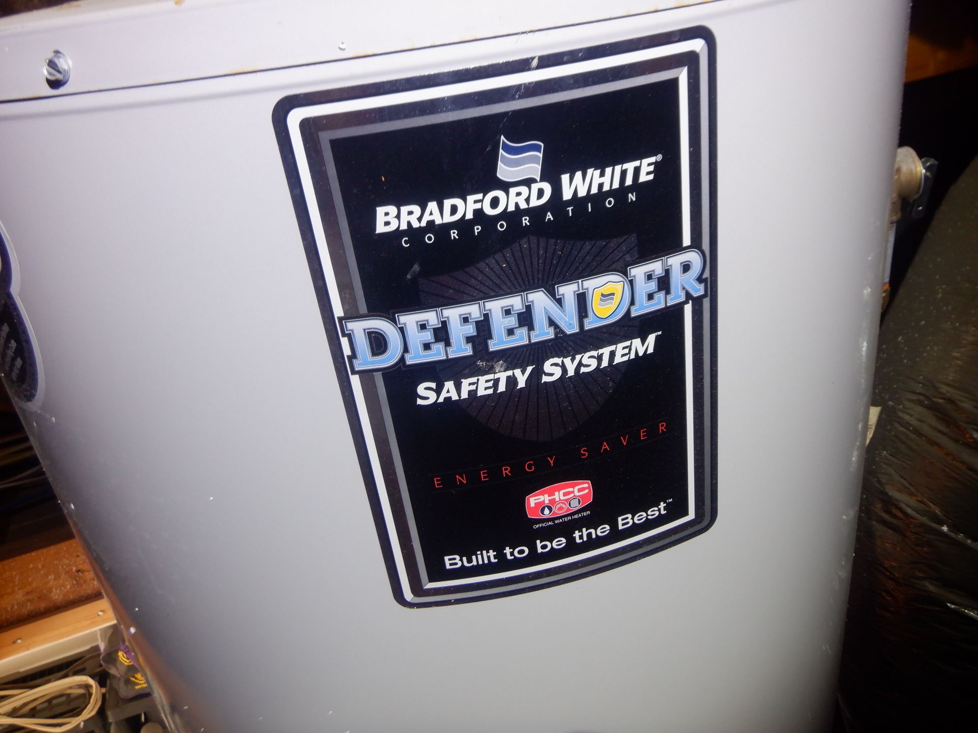 Bradford White Defender water heater with black label on a white tank.