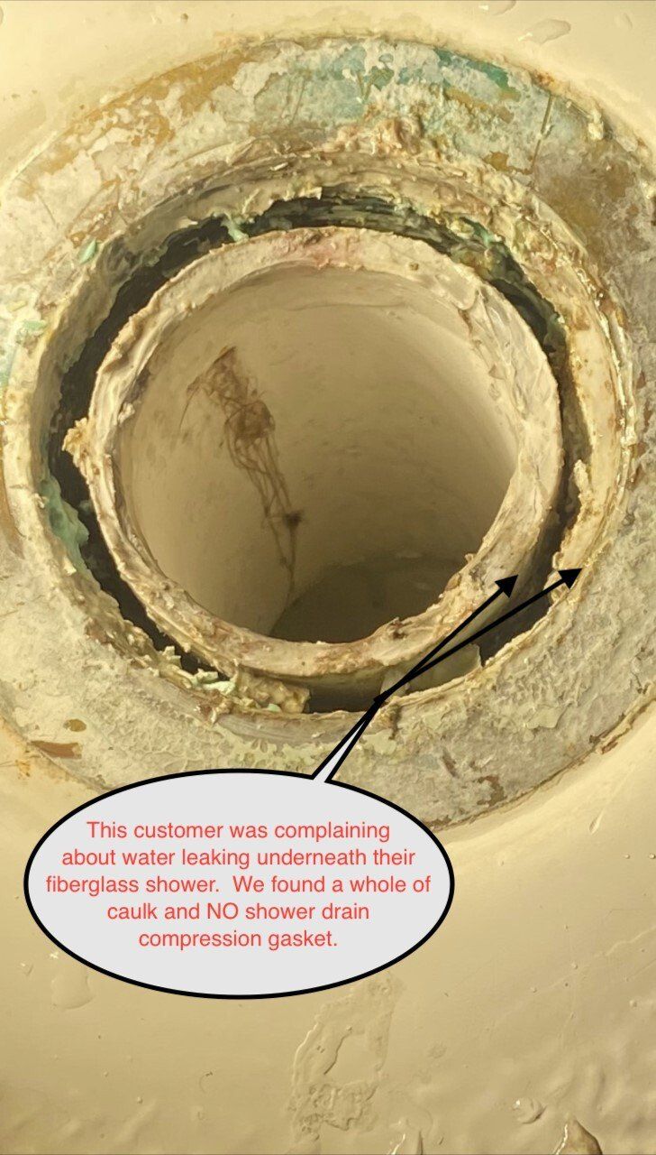 Close-up of a plumbing pipe with corroded components; customer complained of water leaking below shower.