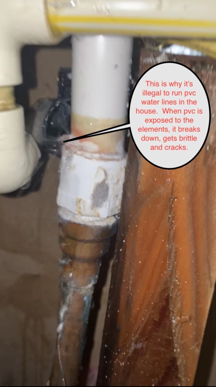 White plumbing pipe with a white fitting and a handwritten label, beside a brown curtain or cord.