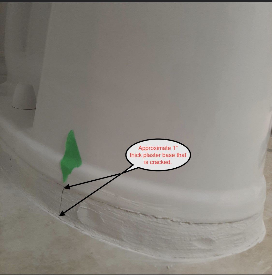 Close-up of a white cylindrical object with a green paint mark and a callout pointing to a seam crack.