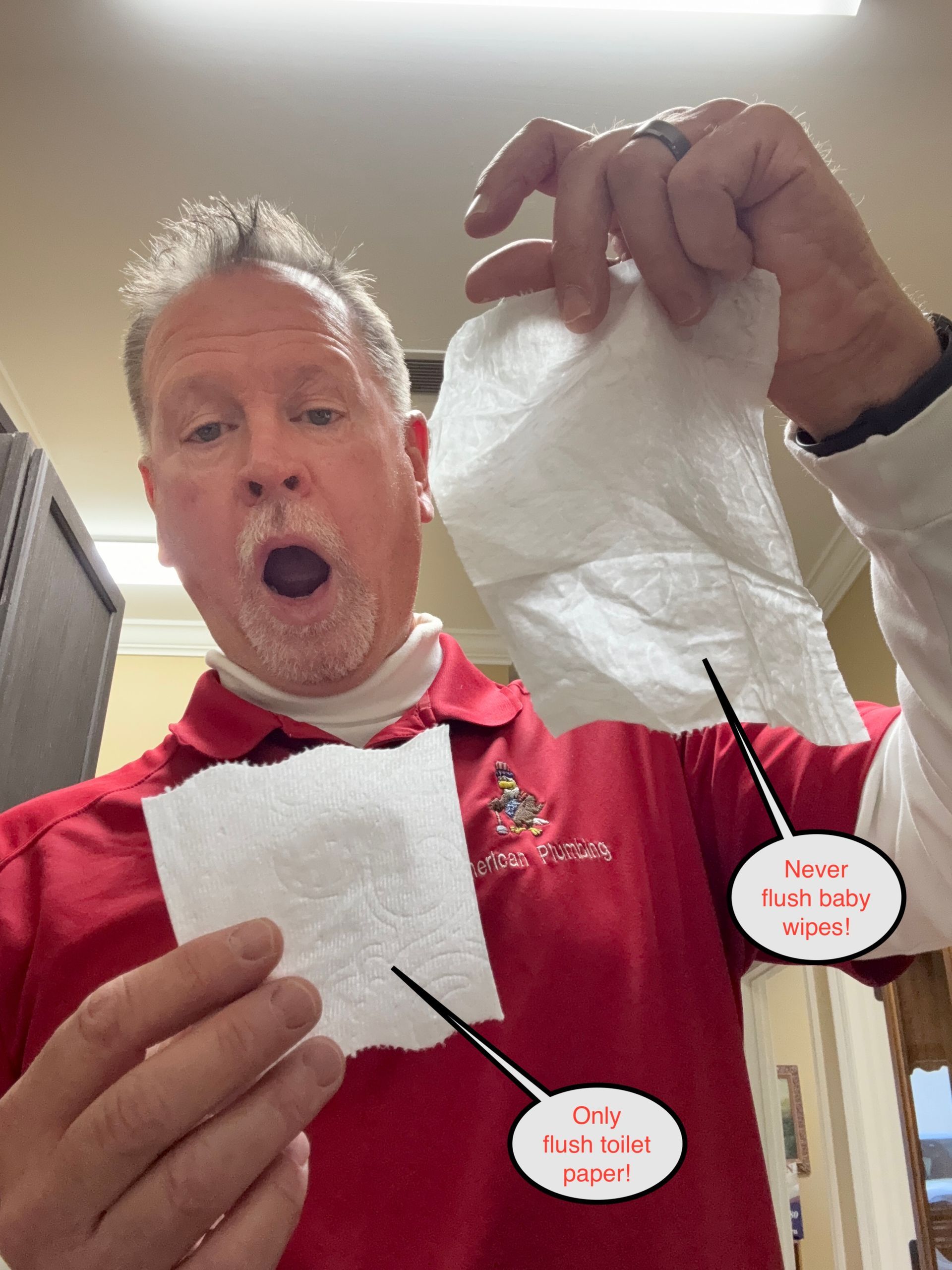 Man in red shirt holds up a tissue, looking surprised, with torn tissue pieces on display.
