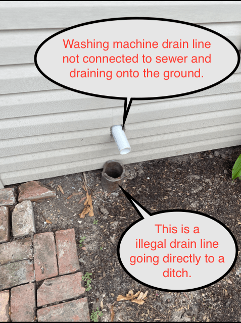 White house drainpipe draining into ground, with callouts noting a washing machine line and illegal drain to ditch.
