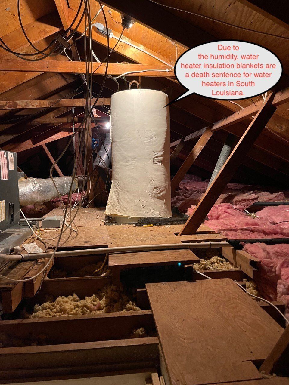 Attic with a water tank wrapped in insulation, rafters, wiring, and loose insulation. Text says foam insulation is a fire hazard.