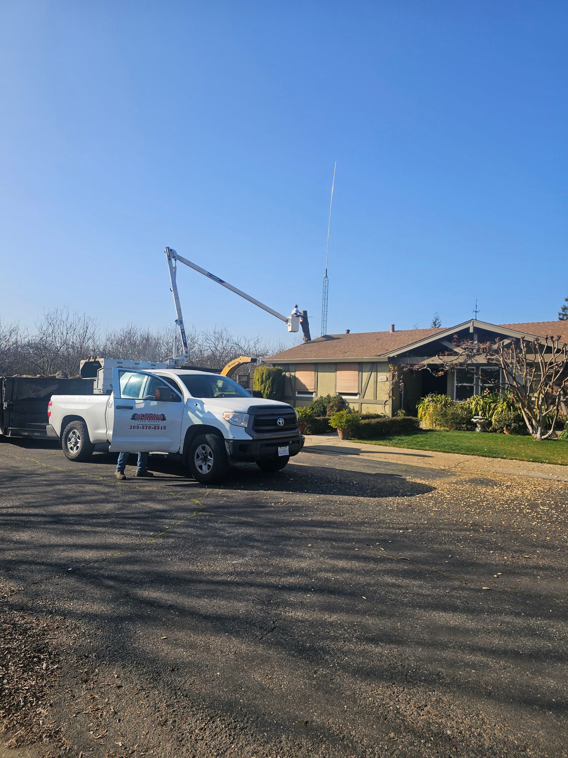 A white truck is parked in front of a house.