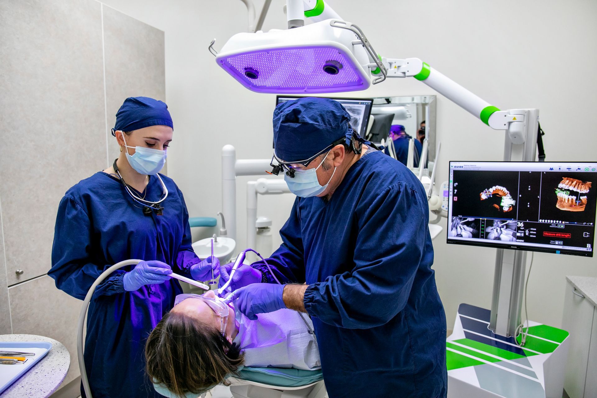Dentists treating a patient at Dr. Ramirez Aesthetic Dentistry in Kitchener