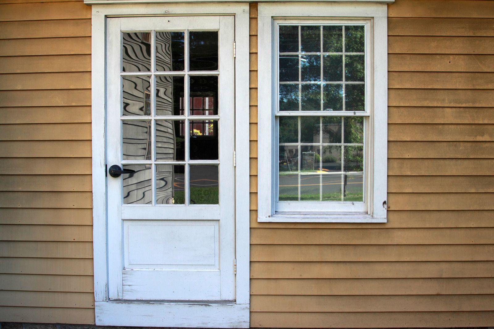 A house with a white door and two windows