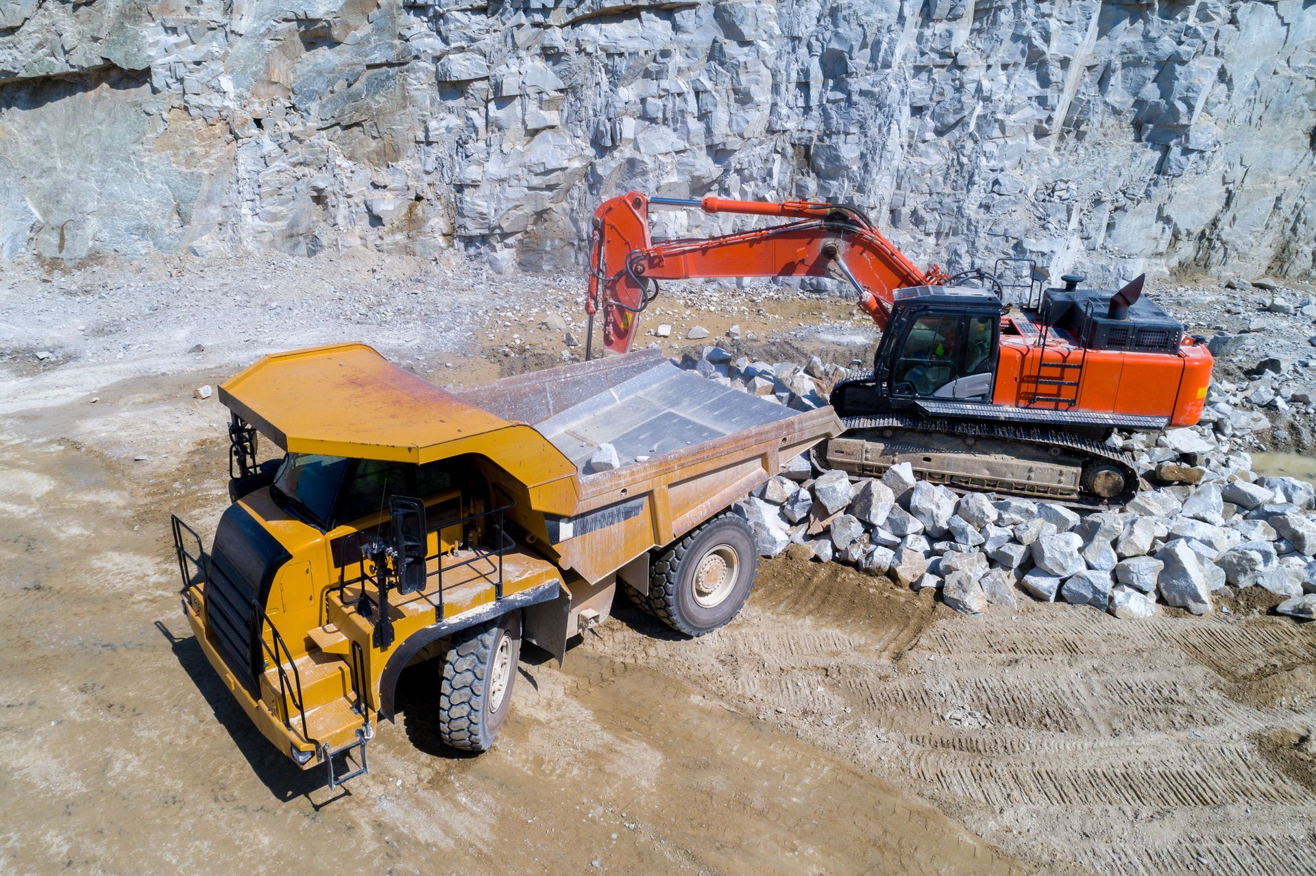 An Aerial View Of A Dump Truck And An Excavator - Columbus, IN - Orville K. Fleetwood Asphalt An Aerial View Of A Dump Truck And An Excavator - Columbus, IN - Orville K. Fleetwood Asphalt