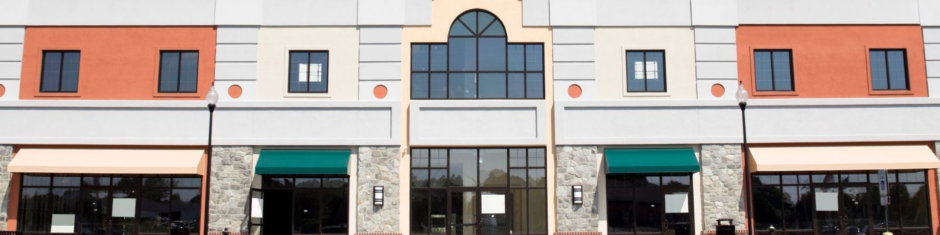 A large building with a lot of windows and awnings.