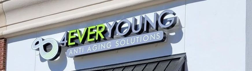 A sign on the side of a building that says `` ever young and aging solutions ''.
