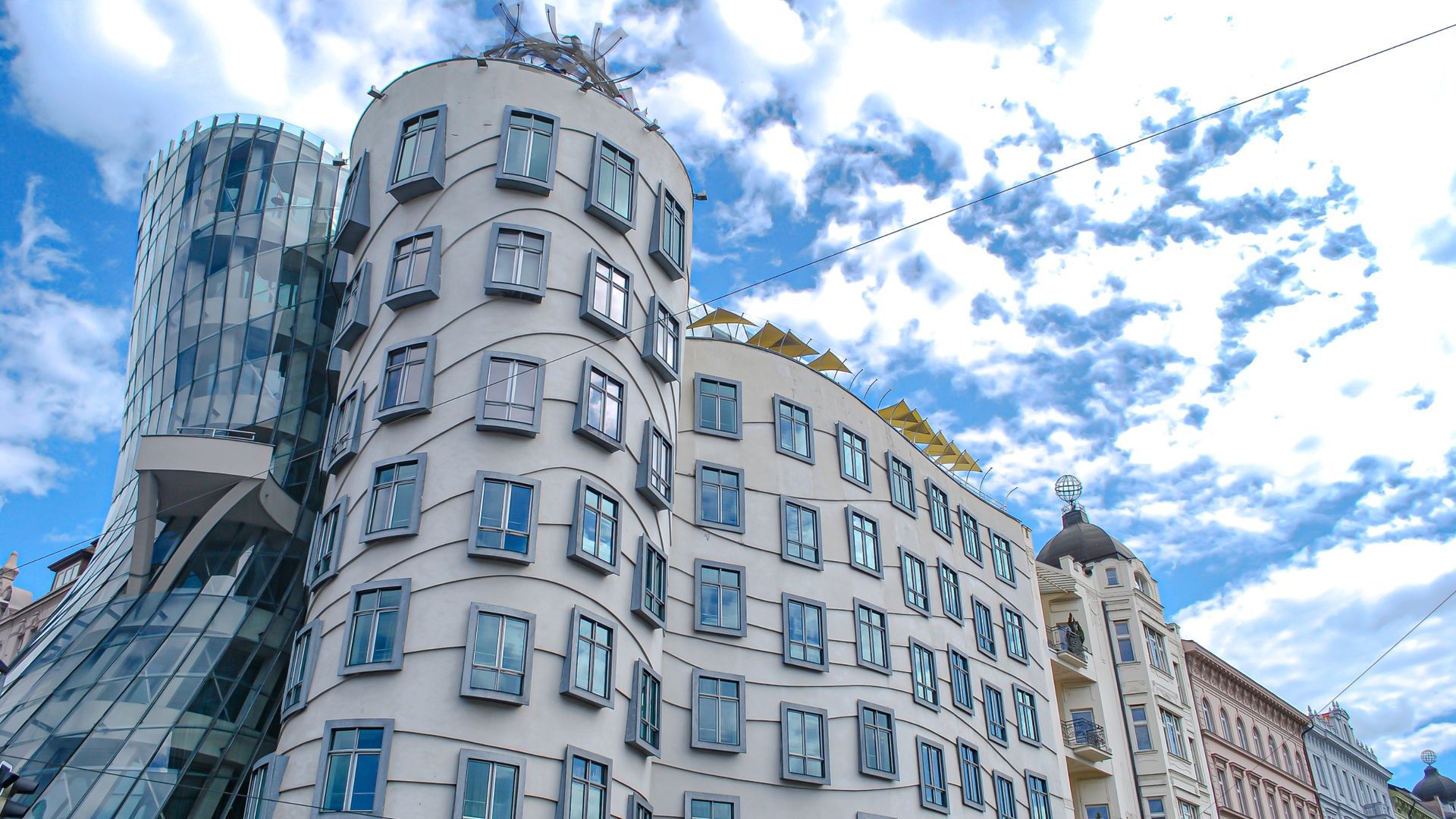 A large building with a lot of windows and a blue sky in the background.