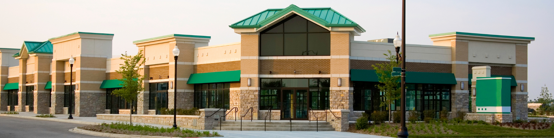 A large building with green awnings and a green roof